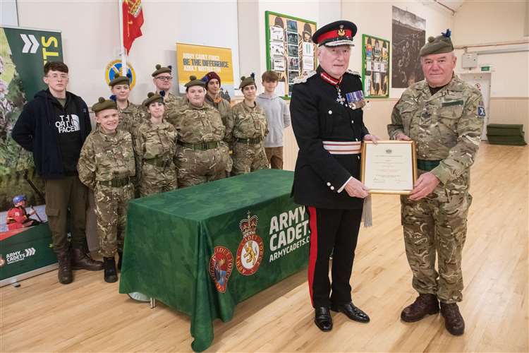 SSI Cowieson (right) is presented with a certificate of high appreciation for his meritorious service to the Army Cadet Force by Major General Monro.