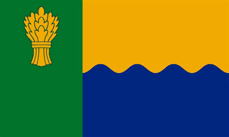 The green hoist and golden garb recall the rich agricultural output of the county, whilst the wavy blue and green reference the sea and sand of the coast.